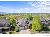 Beautiful two-story home featuring a brick facade, a two-car garage, and a well-maintained front yard at 1513 Cannon Mountain Dr, Longmont, CO 80503