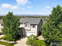 Beautiful two-story home with mature trees and mountain views at 166 Monares Ln, Erie, CO 80516