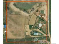 Expansive aerial view of the property's layout, surrounded by farm land with road access at 18247 County Road 22, Fort Lupton, CO 80621