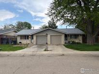 Charming duplex with a two car garage and a well maintained front yard at 1906 Yeager Dr, Longmont, CO 80501