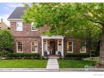 Charming brick home with manicured lawn and mature landscaping, creating a welcoming curb appeal at 3000 E Cedar Ave # 2, Denver, CO 80209