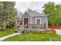 Charming home showcasing a cozy front porch, well-manicured lawn, and a quaint, inviting curb appeal at 340 Vivian St, Longmont, CO 80501