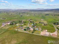 Expansive aerial view of a property with mountain views and a surrounding countryside landscape at 3400 Erving Ct, Berthoud, CO 80513