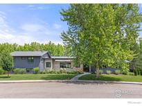Charming home featuring a mix of wood and painted brick exterior with lush green landscaping at 3863 57Th St, Boulder, CO 80301