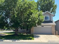 Charming two-story home with well-maintained lawn and mature trees shading the front at 6924 Quigley Cir, Firestone, CO 80504
