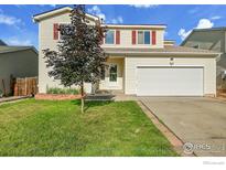 Charming home featuring a two-car garage, well-kept lawn, and curb appeal at 1226 Fremont Ct, Longmont, CO 80504