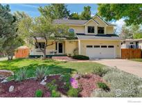 Charming two-story home featuring a well-manicured lawn and beautiful landscaping, creating a welcoming curb appeal at 1620 Oak Ave, Boulder, CO 80304