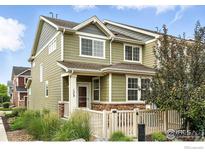 Charming two-story home featuring a welcoming front porch and well-manicured landscaping at 173 Jackson Dr, Erie, CO 80516