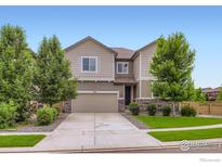 Charming two-story home with landscaped front yard, stone accents, and attached two-car garage in a desirable neighborhood at 286 Western Sky Cir, Longmont, CO 80501