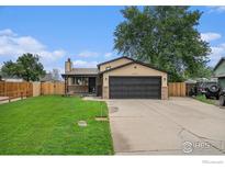 Charming single Gathering home featuring a spacious yard and attached two car garage at 504 David Ct, Platteville, CO 80651