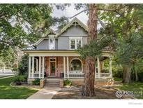 Charming two-story home boasts a welcoming porch with stone accents and classic architectural details at 505 Pine St, Boulder, CO 80302