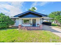 Charming single-story home featuring a covered porch and well-maintained front yard at 707 E Emma St, Lafayette, CO 80026