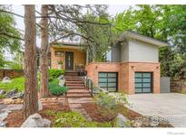Inviting home with brick and siding exterior, two-car garage, and landscaped front yard at 955 Jasmine Cir, Boulder, CO 80304