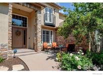 Inviting front entrance with stone accents and a cozy seating area on the front porch at 11433 Decatur Ct, Westminster, CO 80234