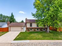 Charming home with a well-manicured lawn, mature tree, and a two-car garage, offering classic curb appeal at 2042 Garfield Ave, Louisville, CO 80027