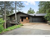 Charming single-story home boasts a mix of stone and wood exterior with an attached two-car garage at 2433 Linden Dr, Boulder, CO 80304