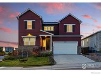 Inviting two-story home boasting a two-car garage, stone accents, and a well-manicured lawn at 4825 Basalt Ridge Cir, Castle Rock, CO 80108