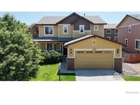 Charming two-story home with a well-manicured lawn and attached two-car garage, located in a desirable neighborhood at 6358 Union Ave, Firestone, CO 80504