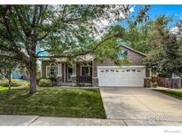 Charming single Gathering home with a spacious driveway and well maintained lawn at 669 Timothy Dr, Longmont, CO 80503