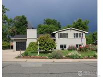 Charming two-story home with landscaped front yard and attached one car garage at 6864 Balsam St, Arvada, CO 80004