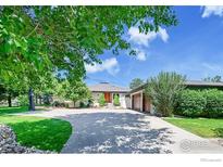 Charming ranch home with a well-manicured front yard, long driveway and an attached two-car garage at 8753 Crimson Clover Ln, Longmont, CO 80503