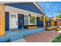 Inviting home front porch with brick walkway, light blue deck, and cheerful decorations at 10731 Blue Jay Ln, Northglenn, CO 80233