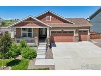 Charming single-story home featuring a welcoming front porch and three-car garage at 1297 Black Haw St, Elizabeth, CO 80107