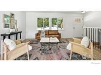 Bright living room with a leather couch, stylish chairs, and a beautiful rug at 1380 Holly E Dr, Broomfield, CO 80020