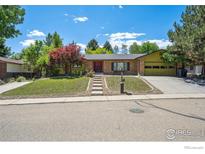 Charming one story brick home with a well-manicured lawn and mature trees in a quiet neighborhood at 2513 Lanyon Dr, Longmont, CO 80503