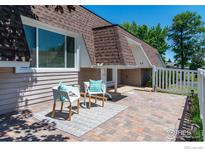 Charming patio with brick flooring and seating creates an inviting outdoor living space at 40 Walter Way, Broomfield, CO 80020