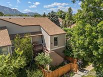View of the property's exterior showing a deck, stairs, and tasteful landscaping at 4717 Tantra Dr # G, Boulder, CO 80305