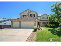 Charming two-story home with a well-manicured lawn, three car garage, and inviting stone accents at 4804 Kingbird Dr, Frederick, CO 80504