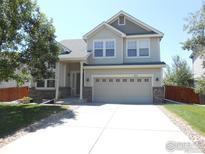 Beautiful two-story home with a spacious two-car garage, and well-kept lawn at 12609 Jersey W Cir, Thornton, CO 80602