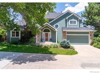 Charming two-story home featuring stone accents, a well-manicured lawn, and a two car garage at 388 Fairfield Ln, Louisville, CO 80027