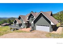 Charming two-story home boasts a spacious garage and a welcoming front patio with mountain views at 4815 Sugarloaf Rd, Boulder, CO 80302