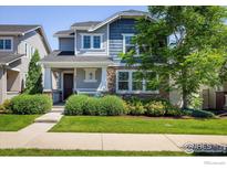 Charming two-story home featuring stone accents, a covered porch, and lush landscaping at 5451 W 73Rd Ave, Westminster, CO 80003