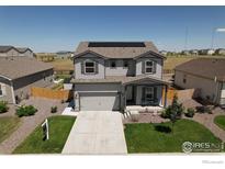 Well-maintained two-story home featuring a two-car garage, solar panels, and a beautifully landscaped front yard at 7414 Blue River Ave, Frederick, CO 80530