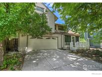 Charming home featuring a two-car garage, inviting front porch, and well-maintained landscaping at 988 Cleveland Ct, Louisville, CO 80027