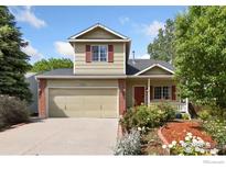 Charming two-story home featuring a well-manicured front yard and attached two-car garage at 1026 Red Oak Dr, Longmont, CO 80504