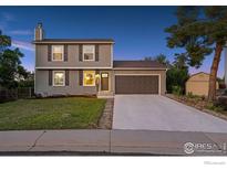 Charming two-story home with well-maintained lawn, two-car garage, and mature landscaping at 10430 Owens Cir, Broomfield, CO 80021