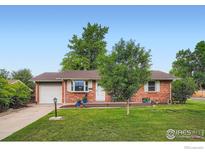 Charming brick home with well-maintained lawn and inviting front porch at 1085 Jade St, Broomfield, CO 80020