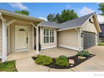 Charming front entrance with landscaped garden and attached two car garage at 142 S Fillmore Ave, Louisville, CO 80027