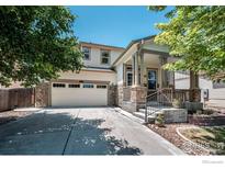 Charming two-story home featuring a stone facade and a well-manicured front yard at 1873 Trevor Cir, Longmont, CO 80501