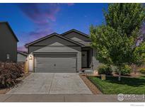 Charming single-Gathering home featuring a two-car garage, a well-maintained lawn and mature landscaping at 2065 Wildwood St, Lochbuie, CO 80603