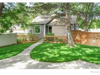 Charming home with a well-maintained lawn, a brick facade, and a walkway leading to the entrance at 2325 N Shore Dr, Longmont, CO 80503