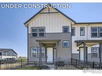 Charming townhome with a well-manicured yard and modern architectural details at 2763 Bear Springs Cir, Longmont, CO 80503