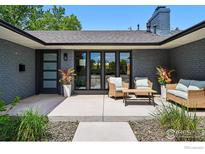 Stylish front porch featuring elegant seating, flower arrangements, and modern brickwork for a welcoming entrance at 3275 19Th St, Boulder, CO 80304