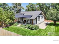 Charming home with solar panels, lush landscaping and a covered front porch at 5326 Lowell Blvd, Denver, CO 80221