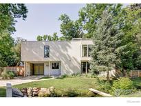 Beautifully landscaped home with modern architectural details and charming water feature at 580 Pleasant St, Boulder, CO 80302