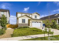 Charming two-story home featuring a two-car garage, stone accents, and a well-maintained lawn at 6645 Dry Fork Dr, Frederick, CO 80516